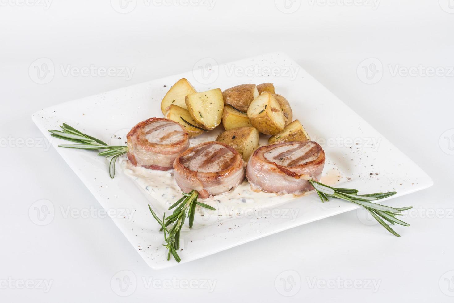 Grilled steak wrapped in bacon, with grilled vegetables, mashed potatoes photo