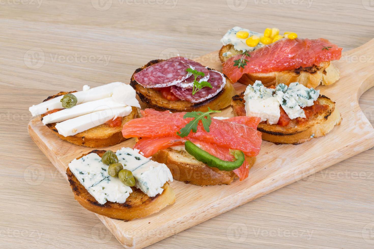 Tapas with cheese, salami and salmon photo