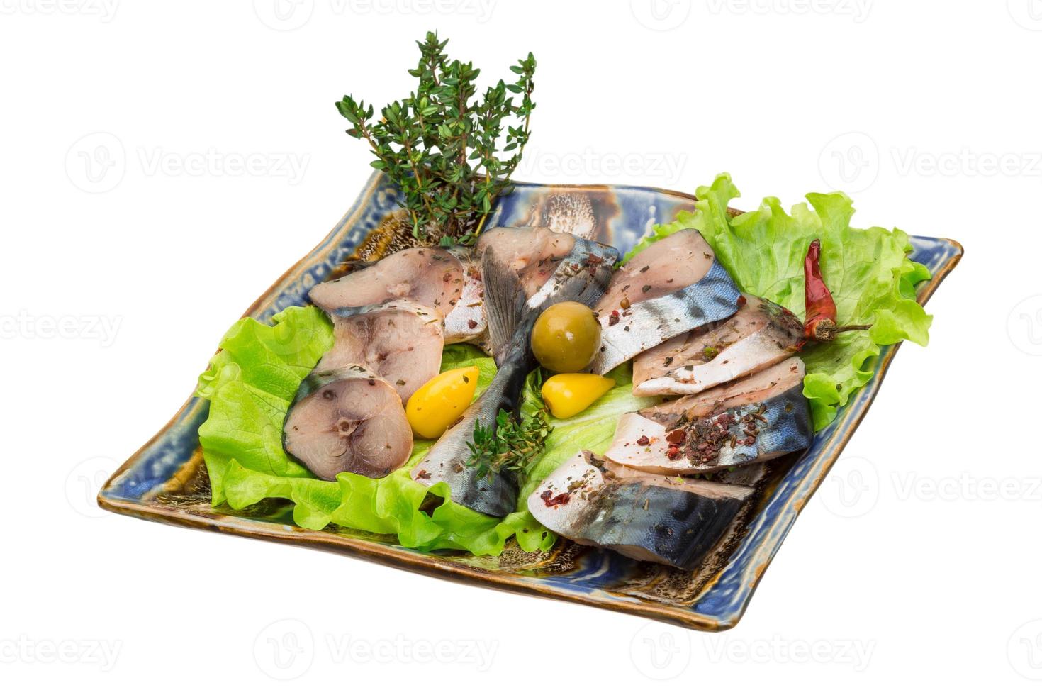 Mackerel fish, sliced on a plate with lettuce photo