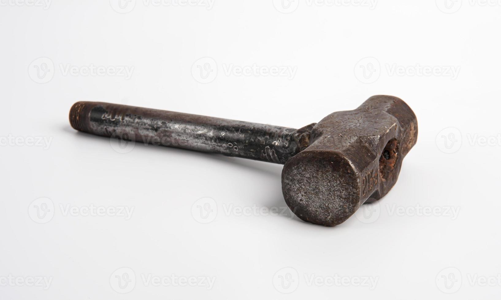 Old rusty hammer with rusty iron handle isolated on white background photo