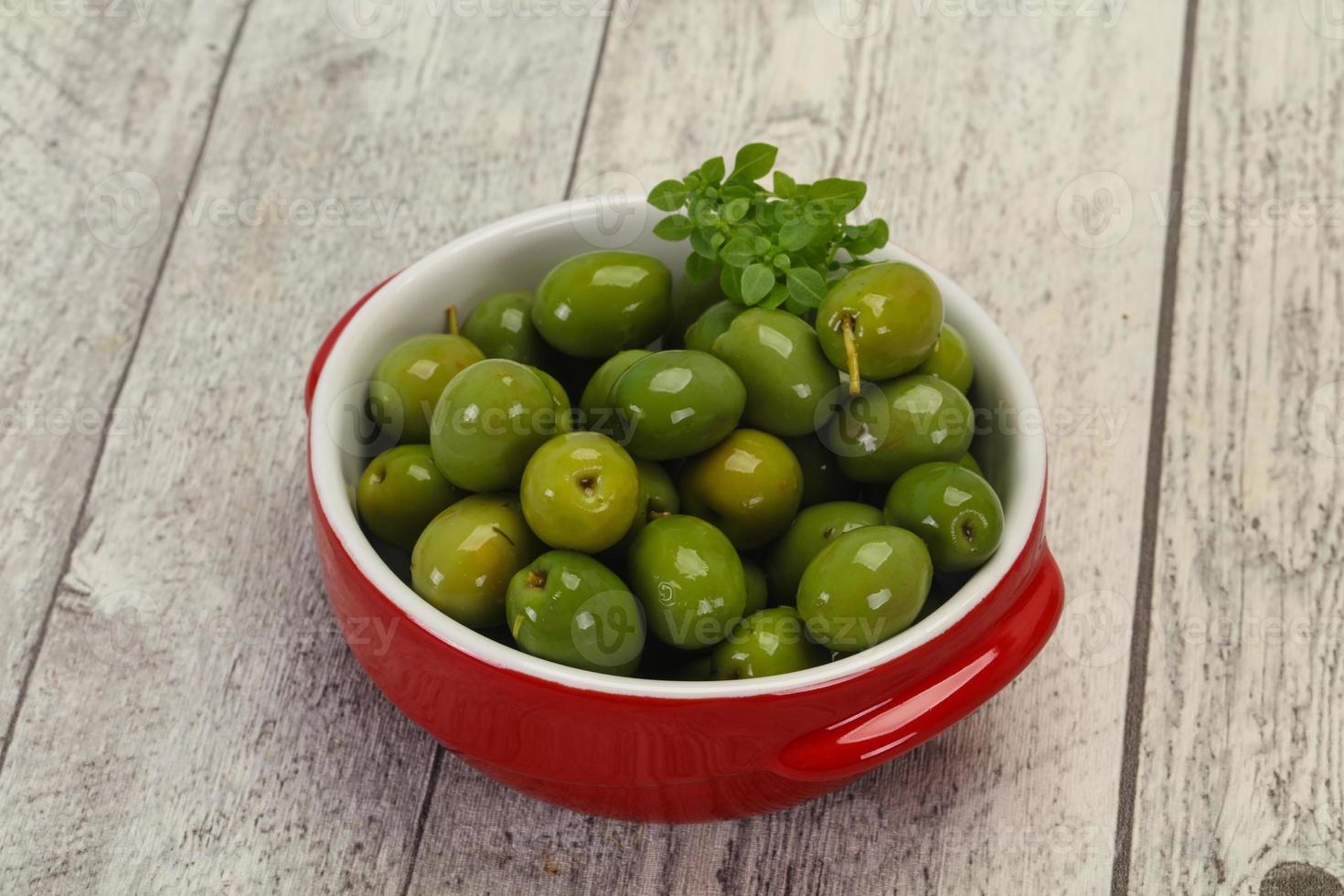 aceitunas verdes de campo real en el bol foto