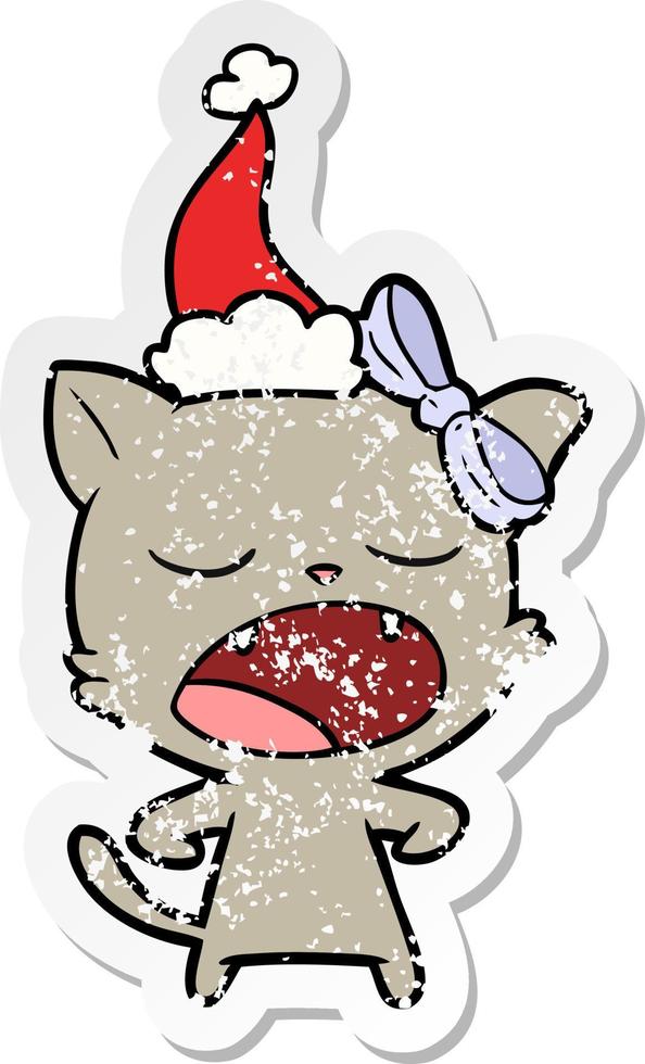 distressed sticker cartoon of a yawning cat wearing santa hat vector