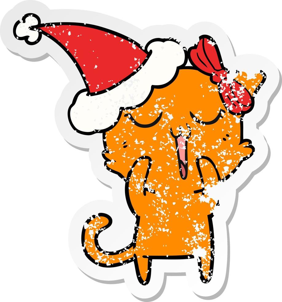 distressed sticker cartoon of a cat wearing santa hat vector