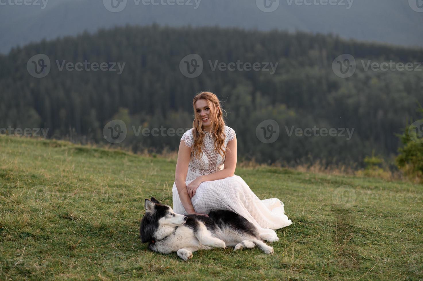 happy stylish bride and groom running and having fun in mountains on summer sunny day photo