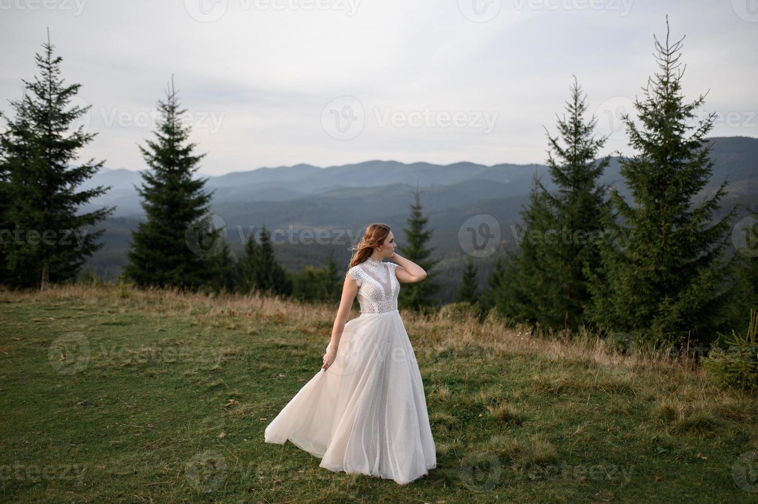 happy stylish bride and groom running and having fun in mountains on summer sunny day photo