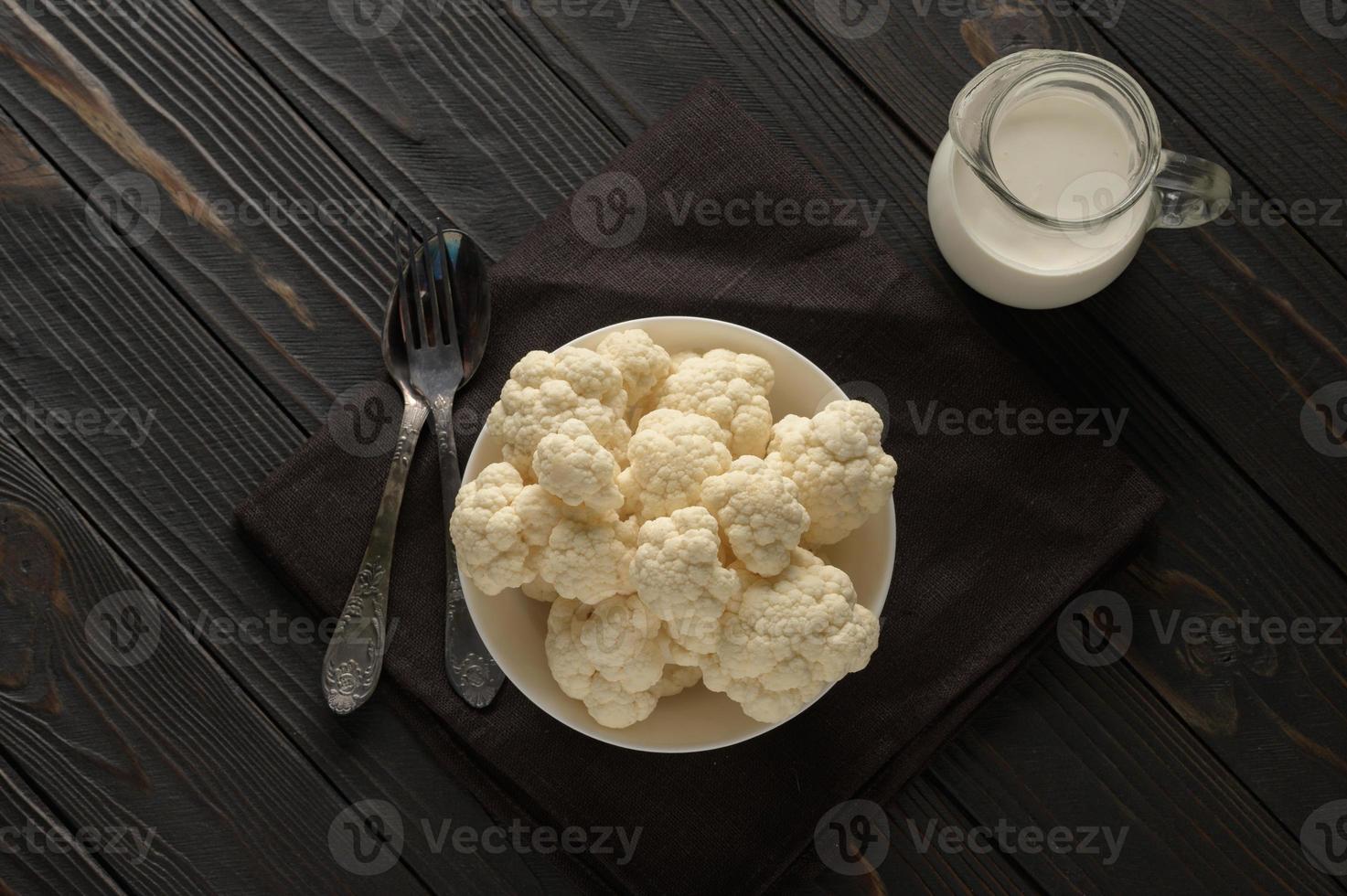 Raw, fresh organic cauliflower on a wooden background. Healthy eating, low carb diet concept photo