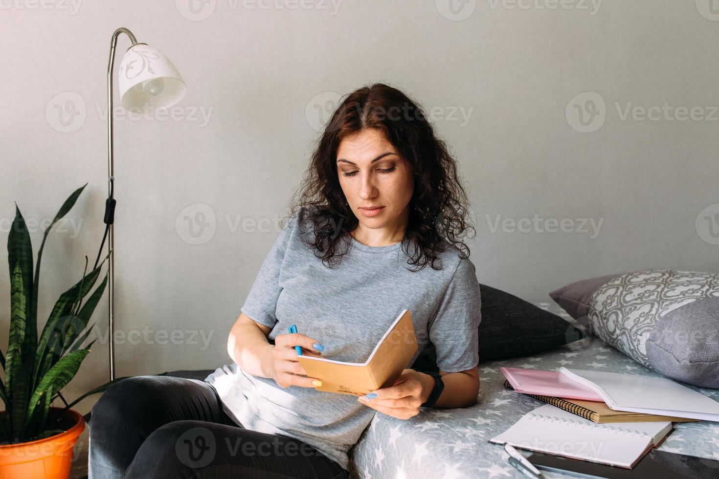 Woman working from home studying. Advanced training, retraining profession. photo