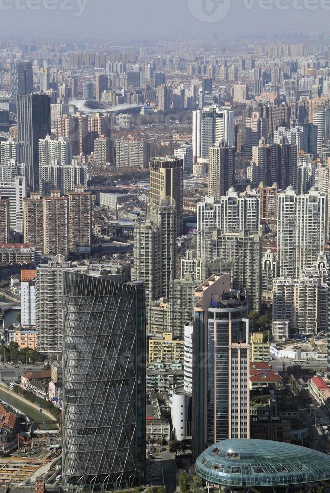 A new skyscraper being added to the rows of tall buildings in Shanghai, China photo