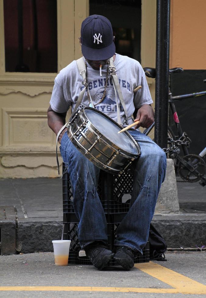 21 April 2016 - New Orleans, Louisiana - A Jazz musician performing a drum solo in the French Quarter of New Orleans, Louisiana. photo