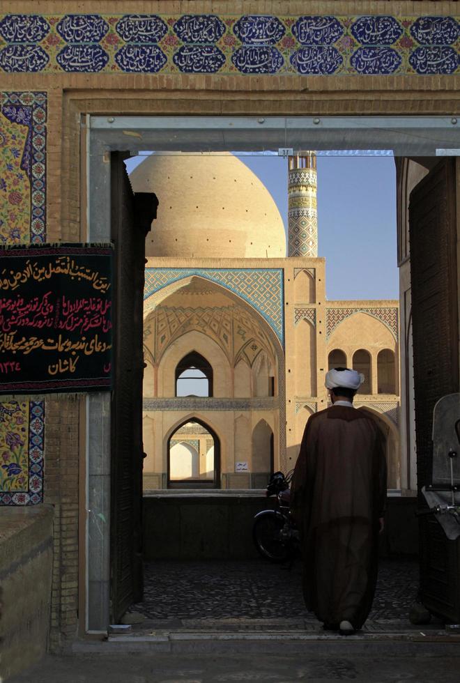 Kashan, Iran - June 14, 2018 - A man enters the square in front of the famous Agha Bozorg Mosque in Kashan Iran. photo