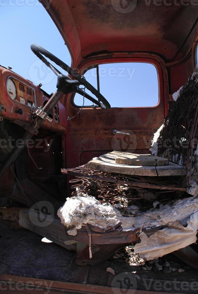 Abandoned car in Death Valley, California, with the steering wheel in the foreground photo