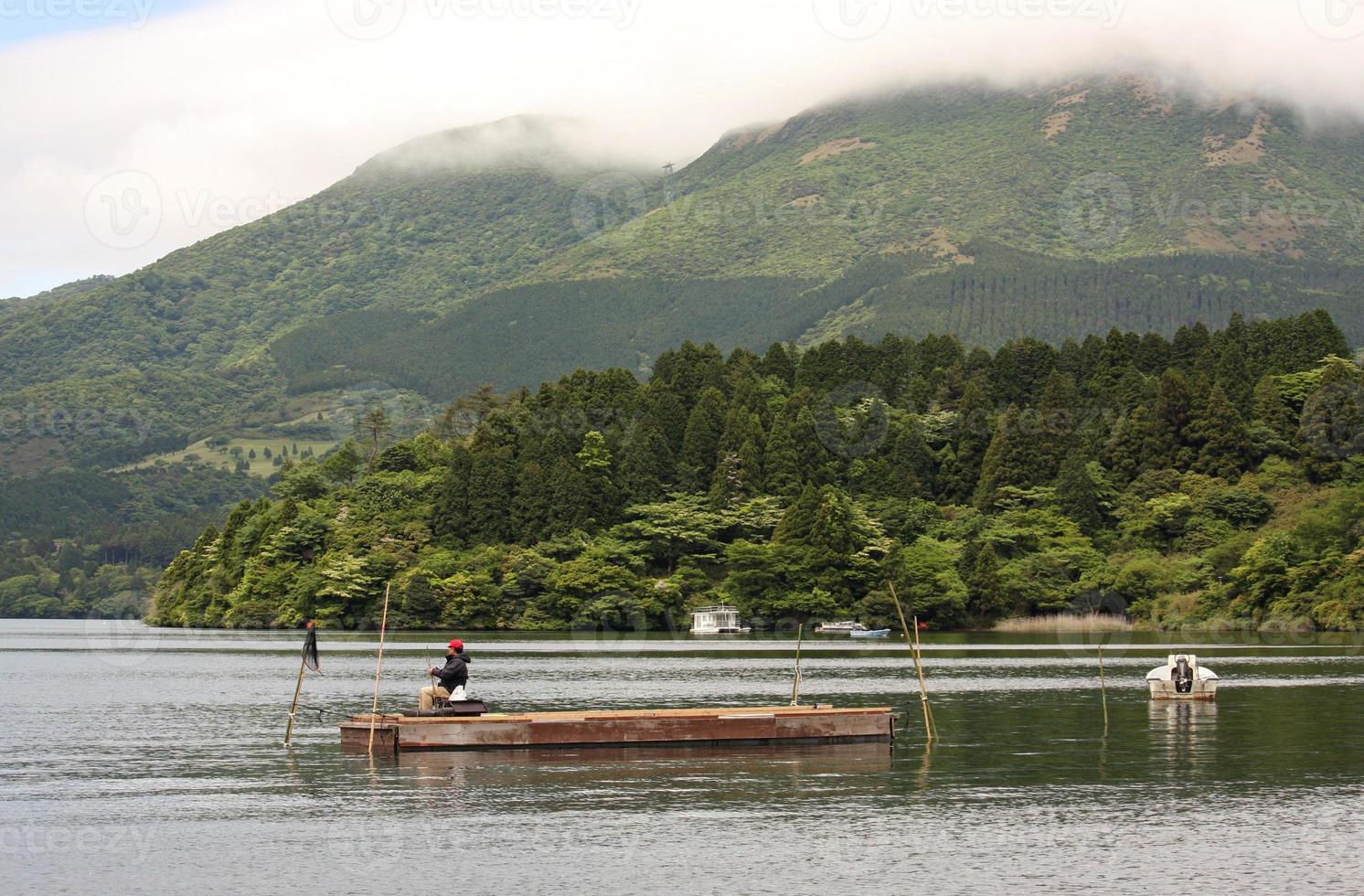 Man fishing on lake Ashinoko, Hakone, Japan photo