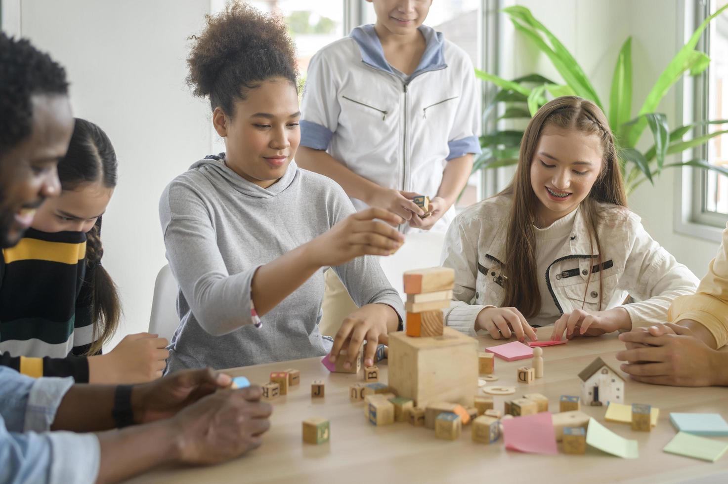 group of students studying and playing with teacher, education and learning concept. photo