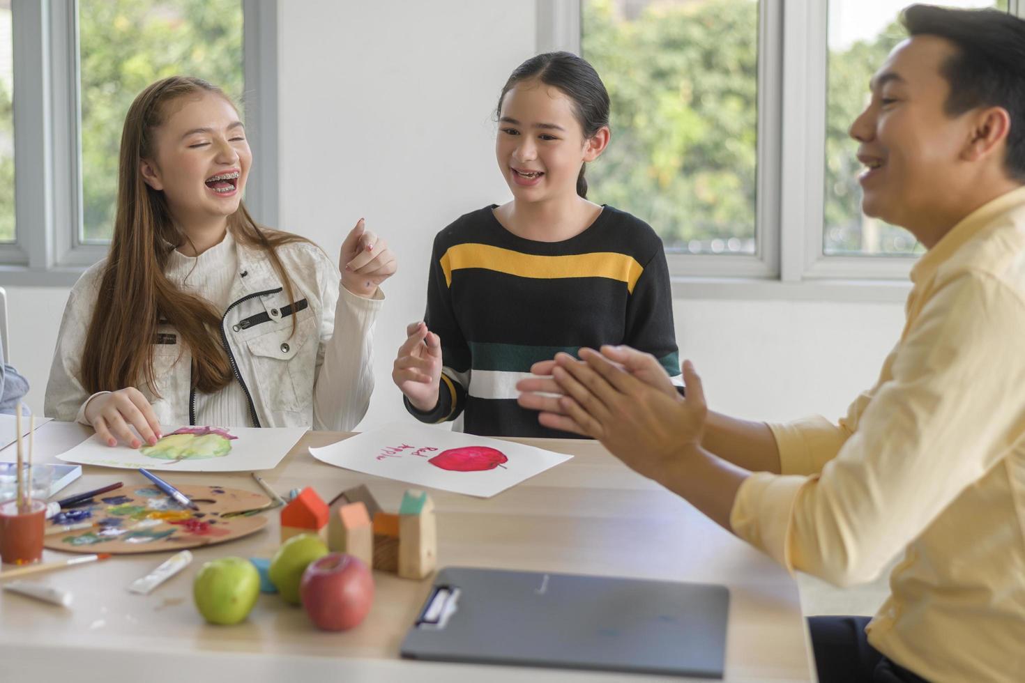 group of students studying and playing with teacher, education and learning concept. photo