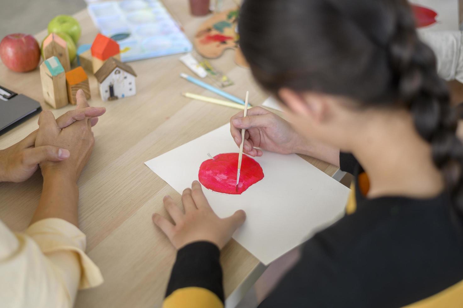 group of students studying and playing with teacher, education and learning concept. photo