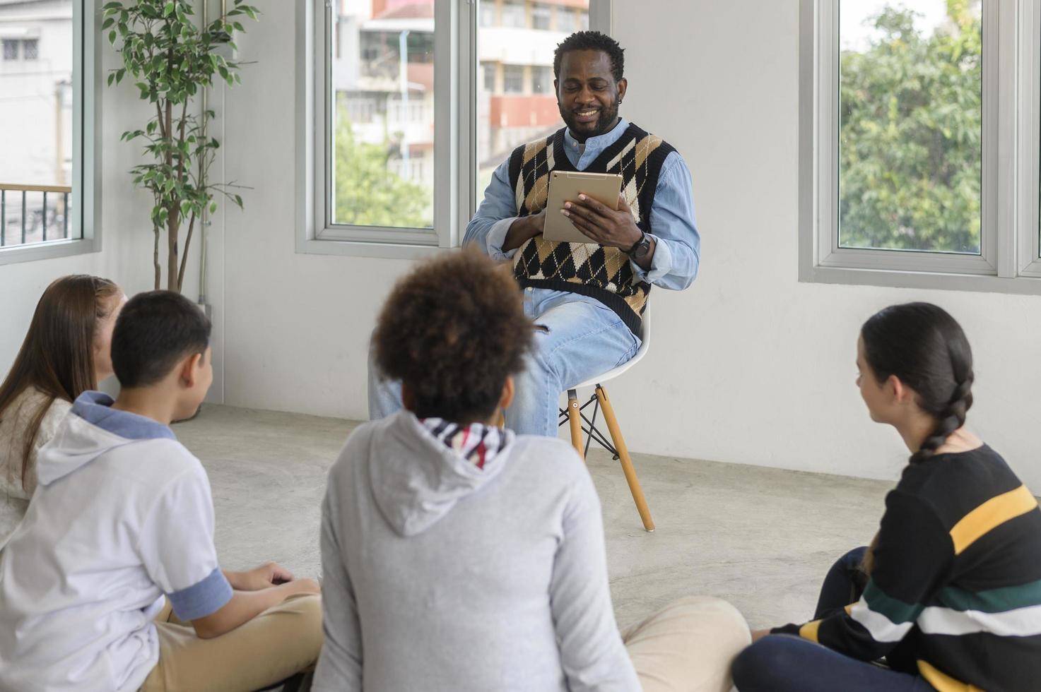 group of students studying and playing with teacher, education and learning concept. photo