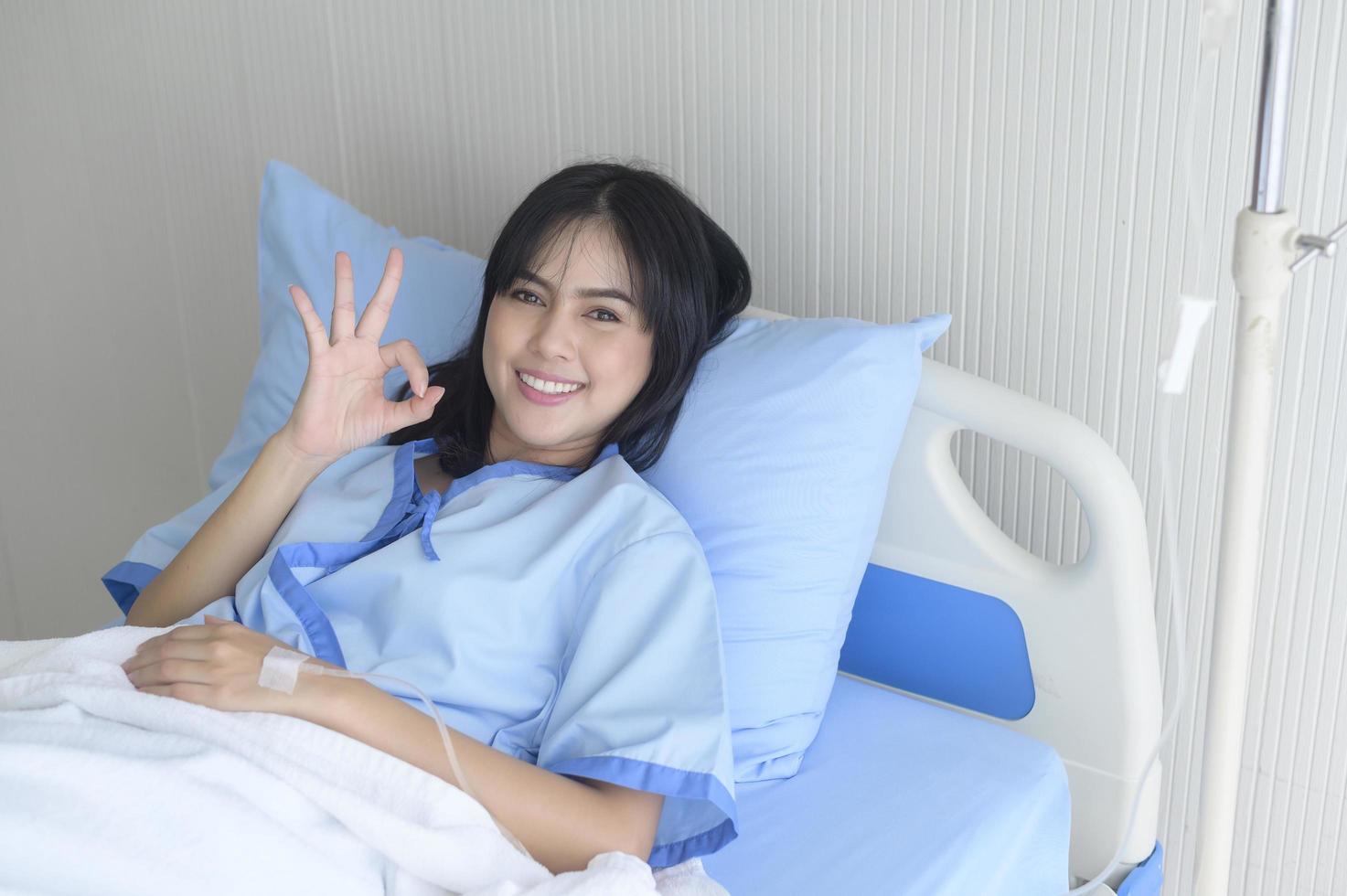 Hopeful and happy young patient woman in hospital, healthcare and medical concept photo