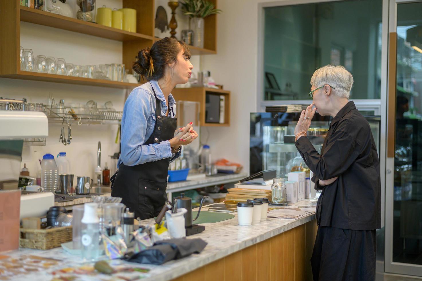 Angry customer complaining about barista in coffee shop photo