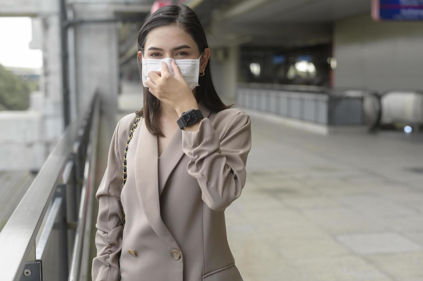 A portrait of  Businesswoman is wearing face mask work in modern City , people lifestyle , working under Covid-19 pandemic concept photo