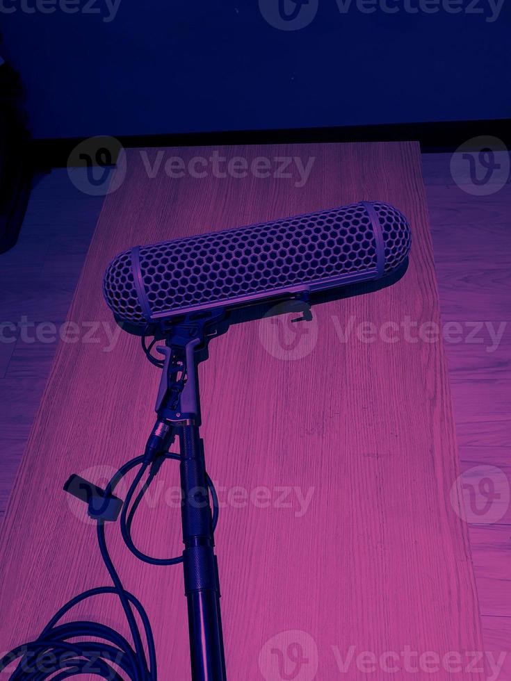 Boom microphones lay down on wood table after using photo