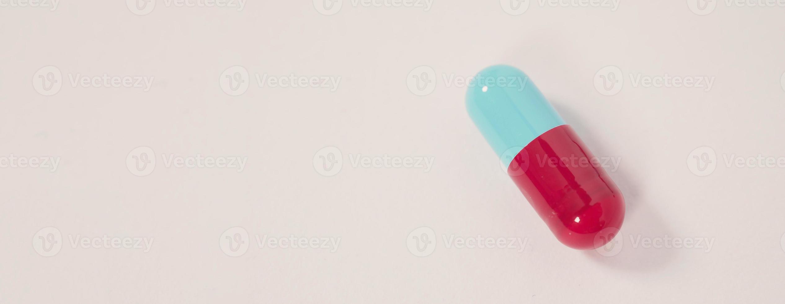 Taking or holding medication pills in hand. Capsule pill on white background. photo