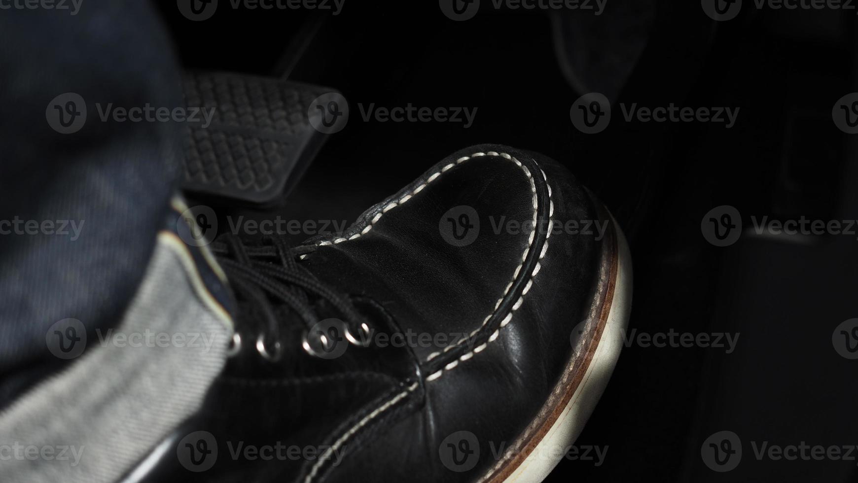 Accelerate and Brake. Foot pressing foot pedal of a car to drive ahead. photo
