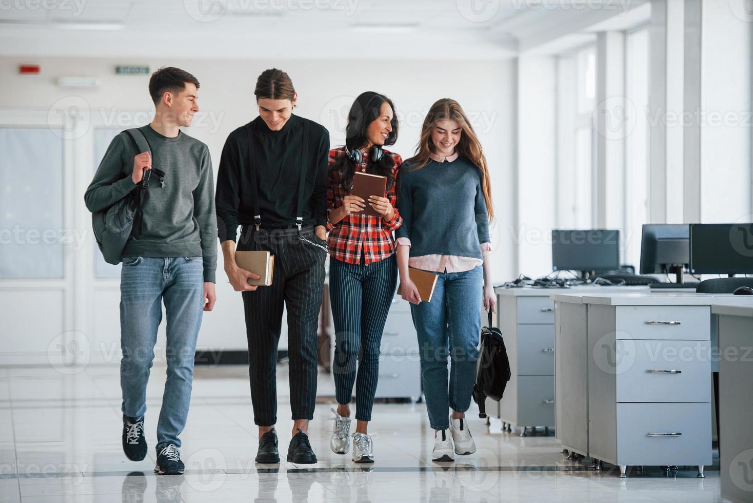 After work. Group of young people walking in the office at their break time photo