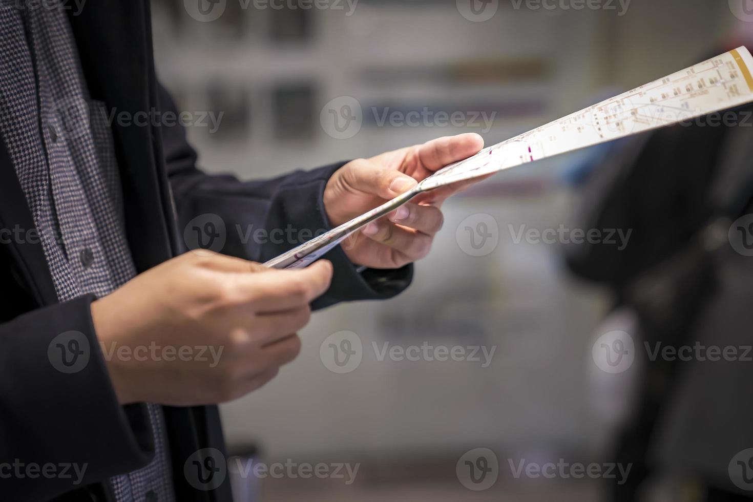 Asian male holds and reads a Japan metro train subway  underground. photo