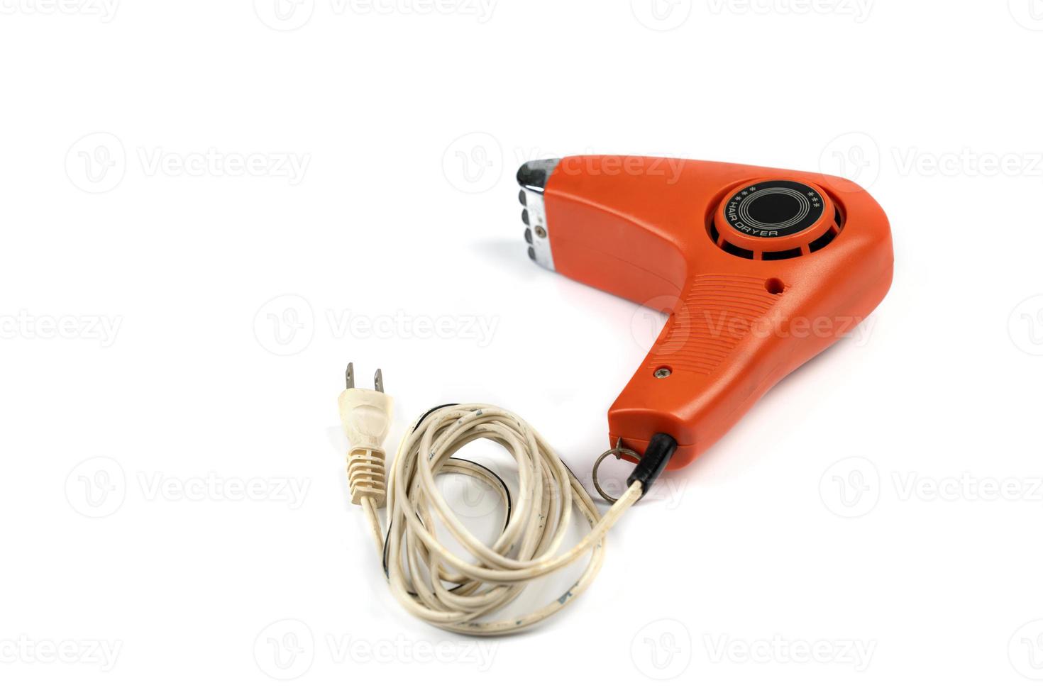 Vintage orange hair dryer on white background with rolled cable buttom. photo