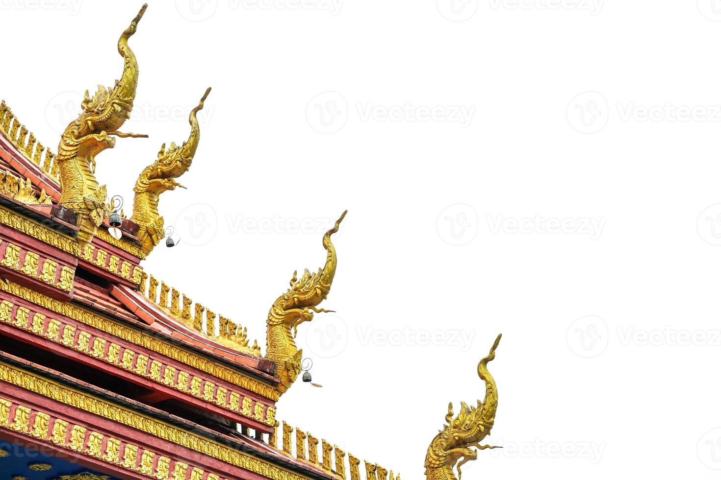 gold king of snake statue on the temple rooftop. photo