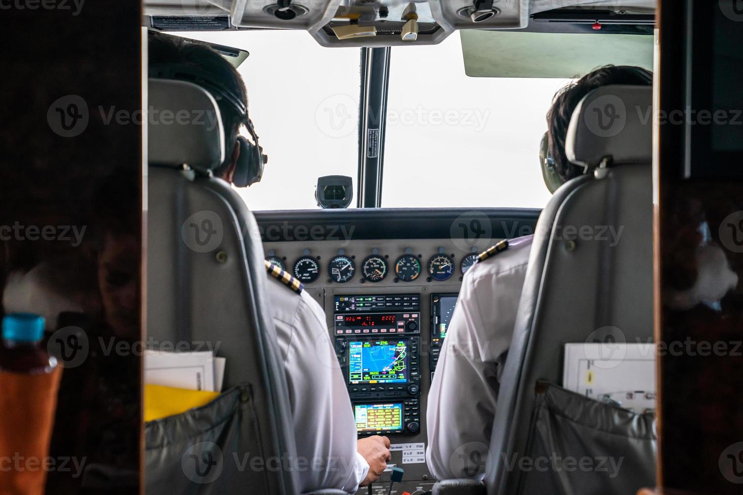 close up 2 pilots concentrate drive the small private jetplane on the sky. photo