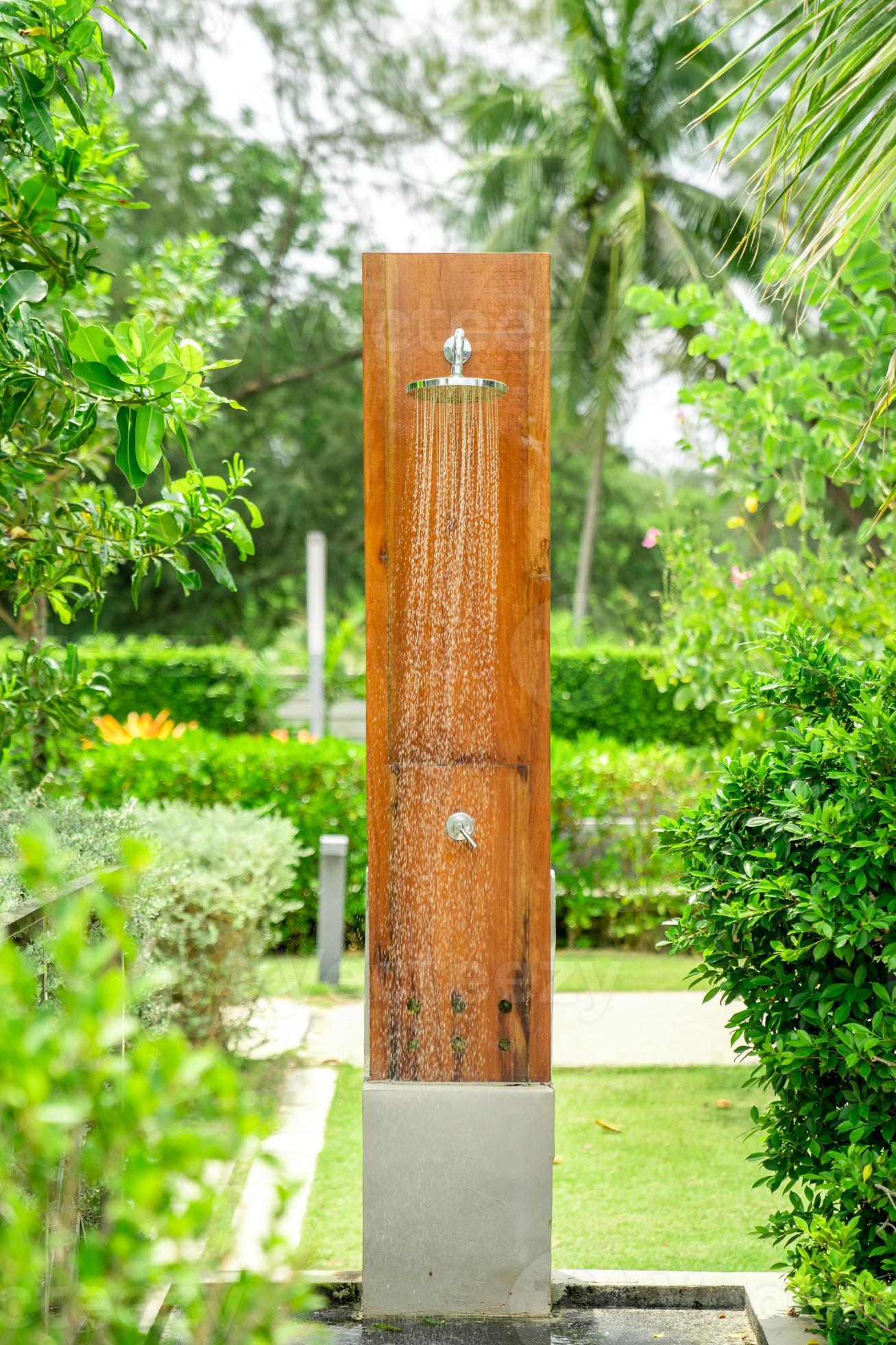 Outdoor shower head stick on the wooden plate pole design for showering