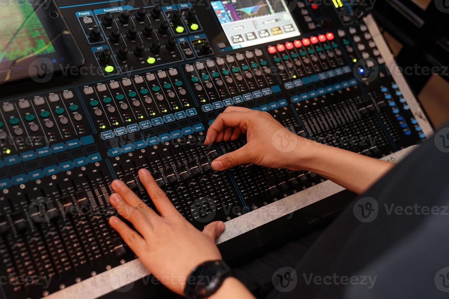 closeup to the DJ's hand with the mixer in mini concert at night. photo