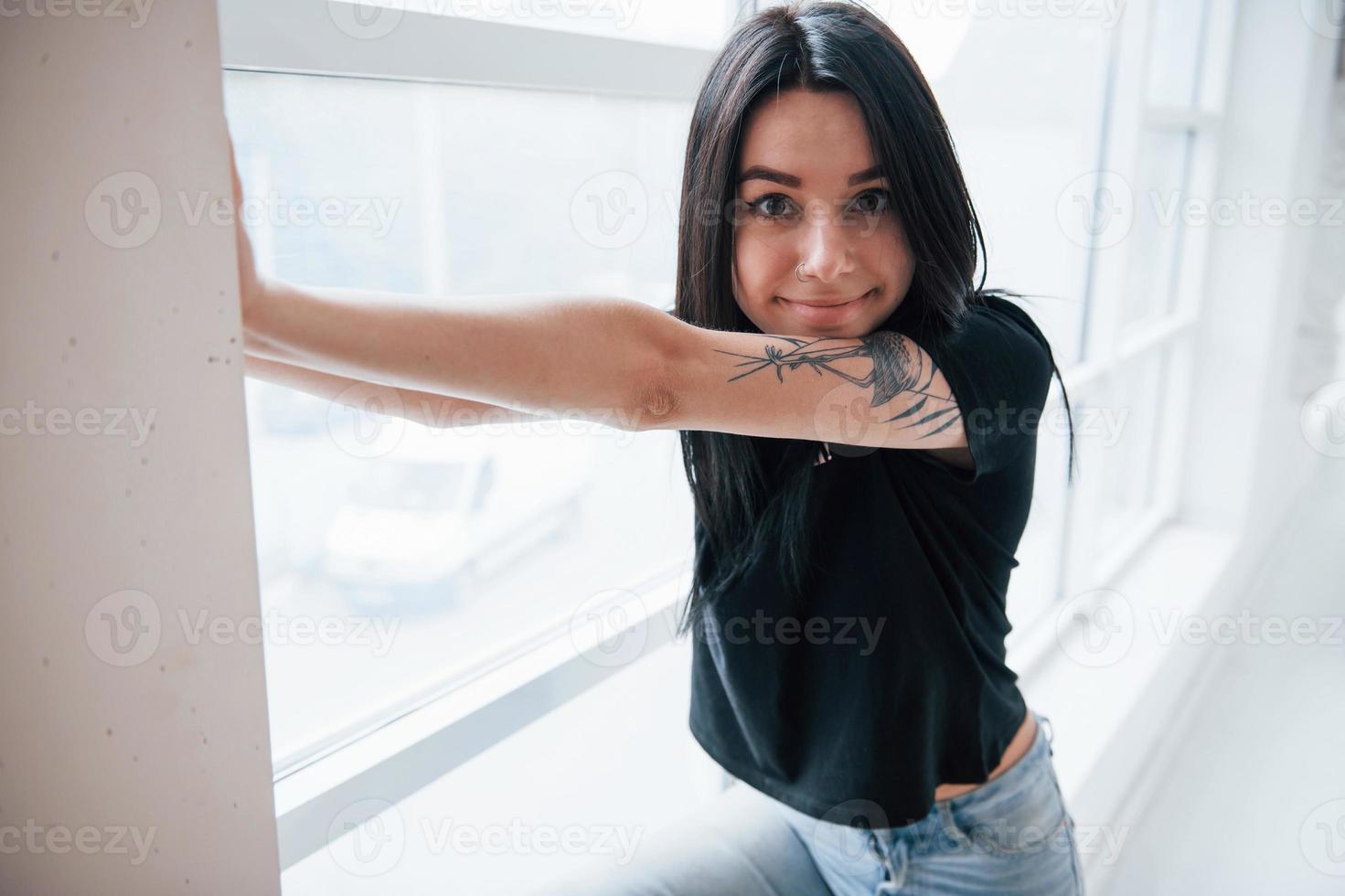 Close up view. Young female brunette teen have photoshoot in the studio at daytime photo