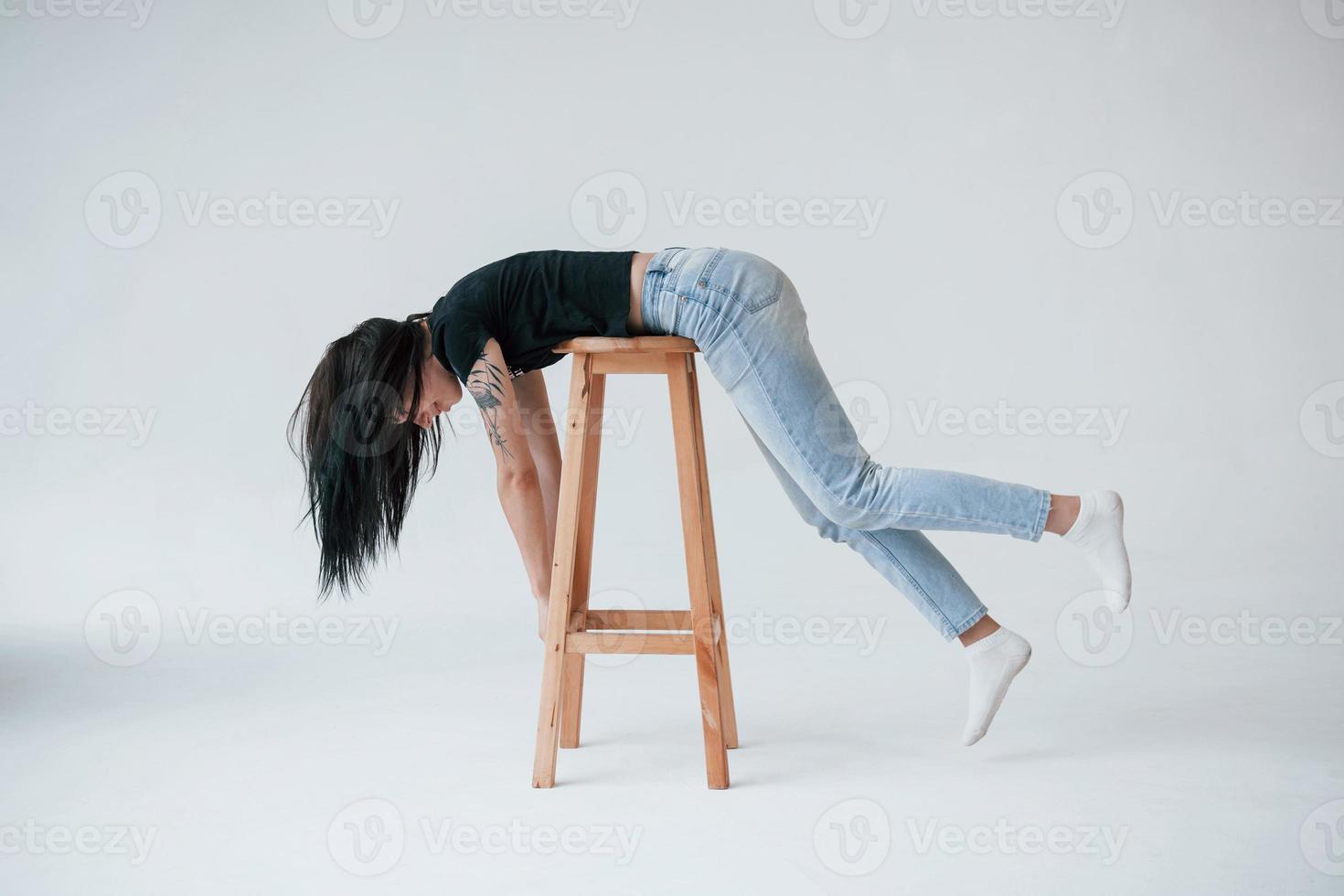Just having some fun. Young female brunette teen have photoshoot in the studio at daytime photo