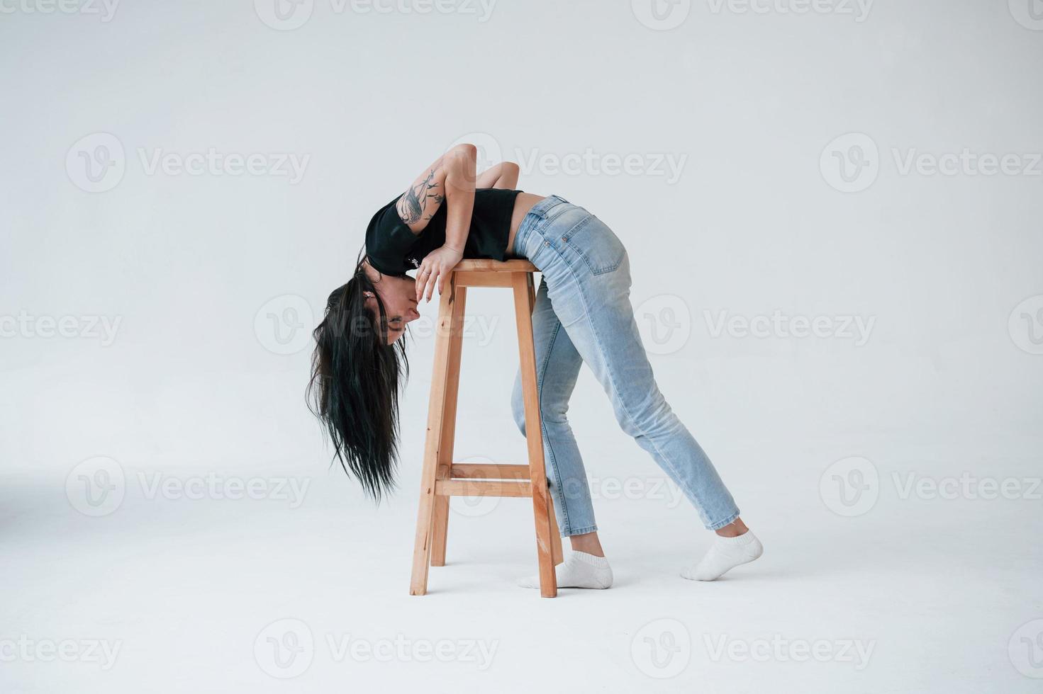 Playful mood. Young female brunette teen have photoshoot in the studio at daytime photo