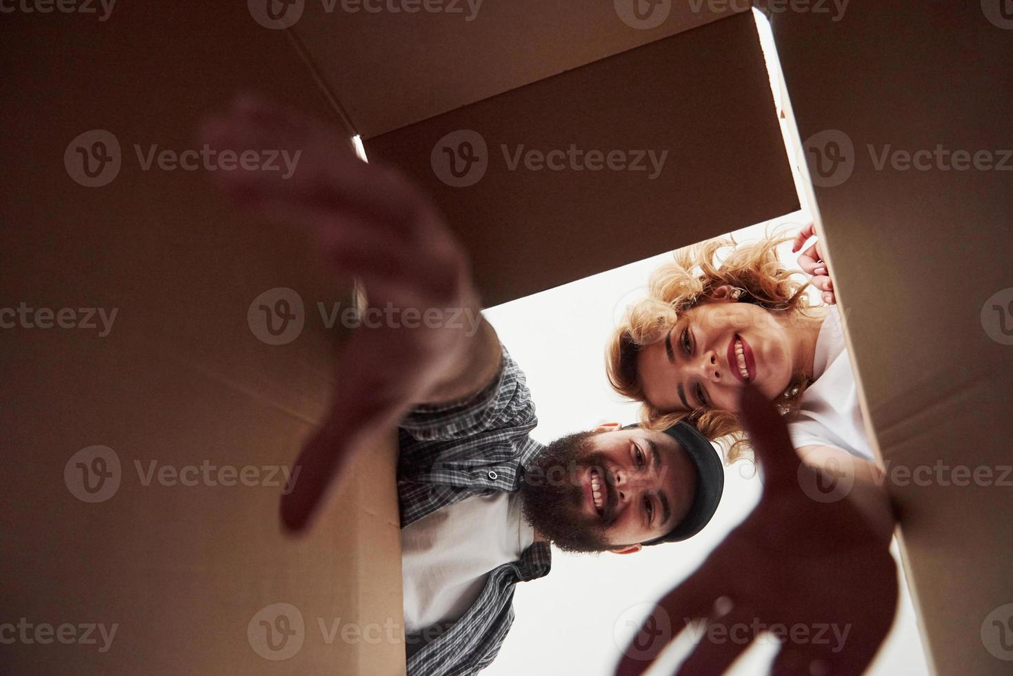 With elongated hands. Happy couple together in their new house. Conception of moving photo