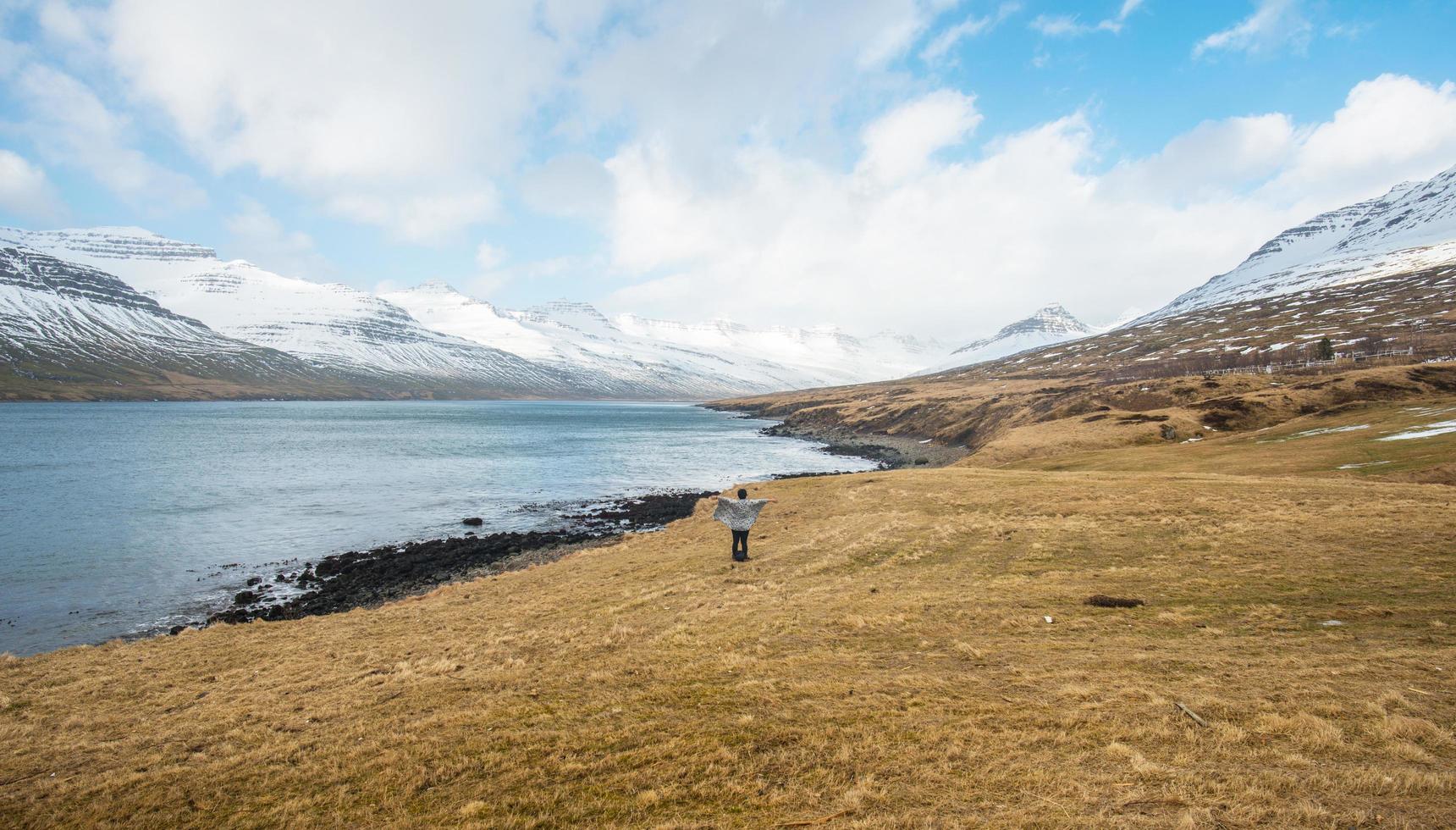 Women journey in the east fjord of Iceland with beautiful mountains range. photo
