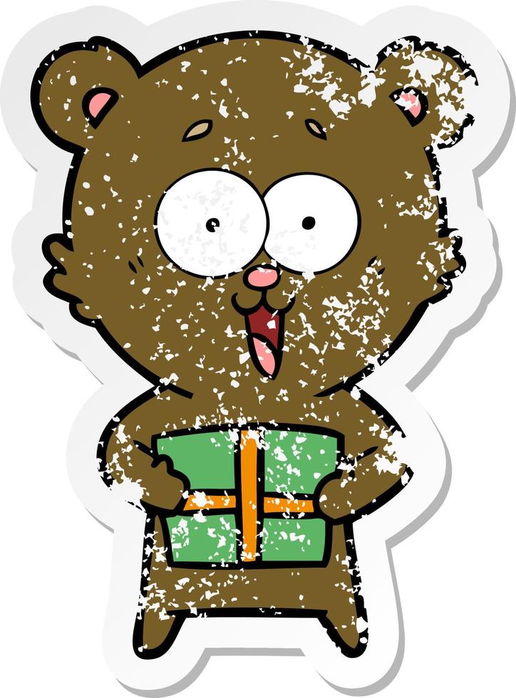 distressed sticker of a laughing teddy  bear with christmas present vector