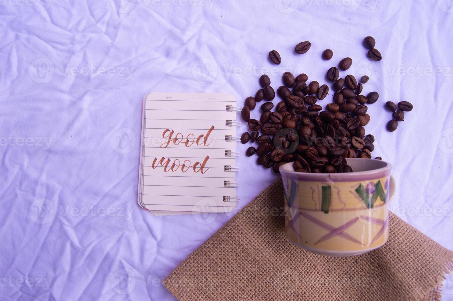 selective focus of coffee beans with diary writing isolated on white photo
