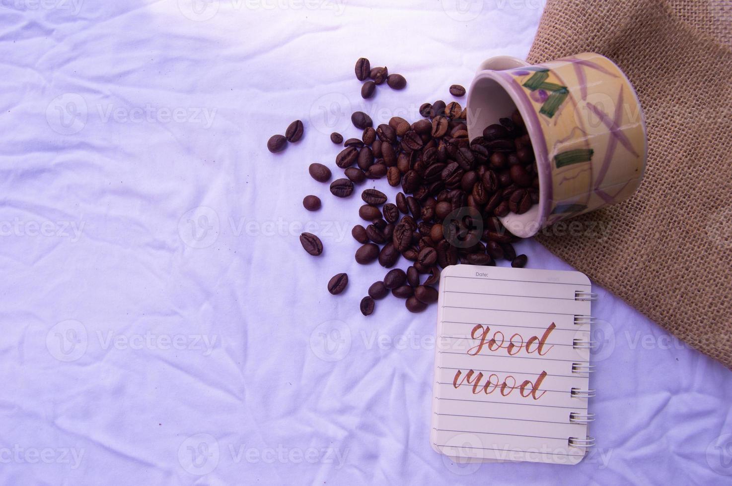 selective focus of coffee beans with diary writing isolated on white photo