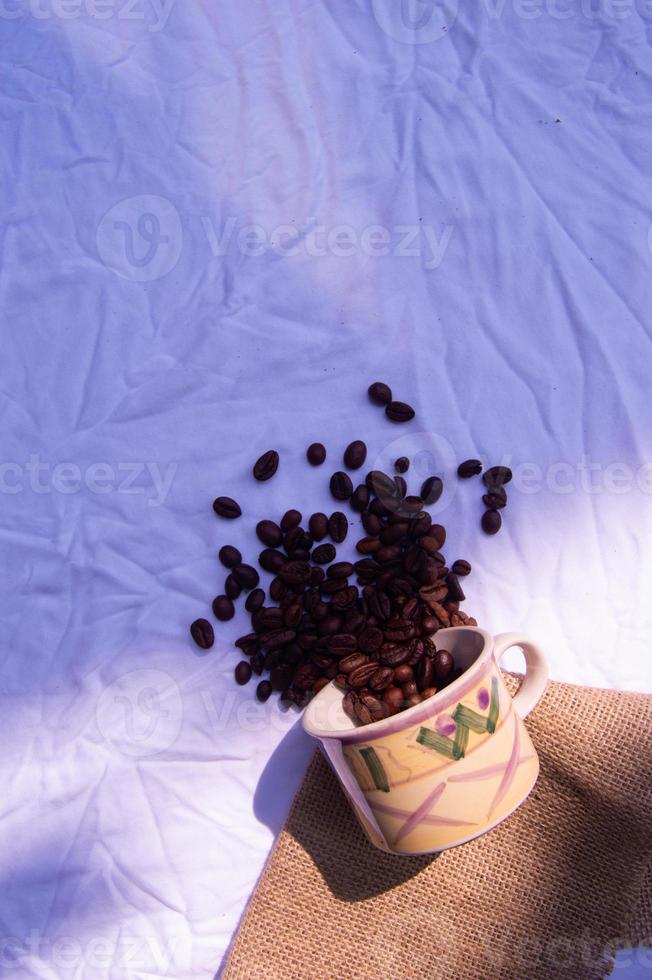 coffee bean background spilled in glass. isolated white background photo