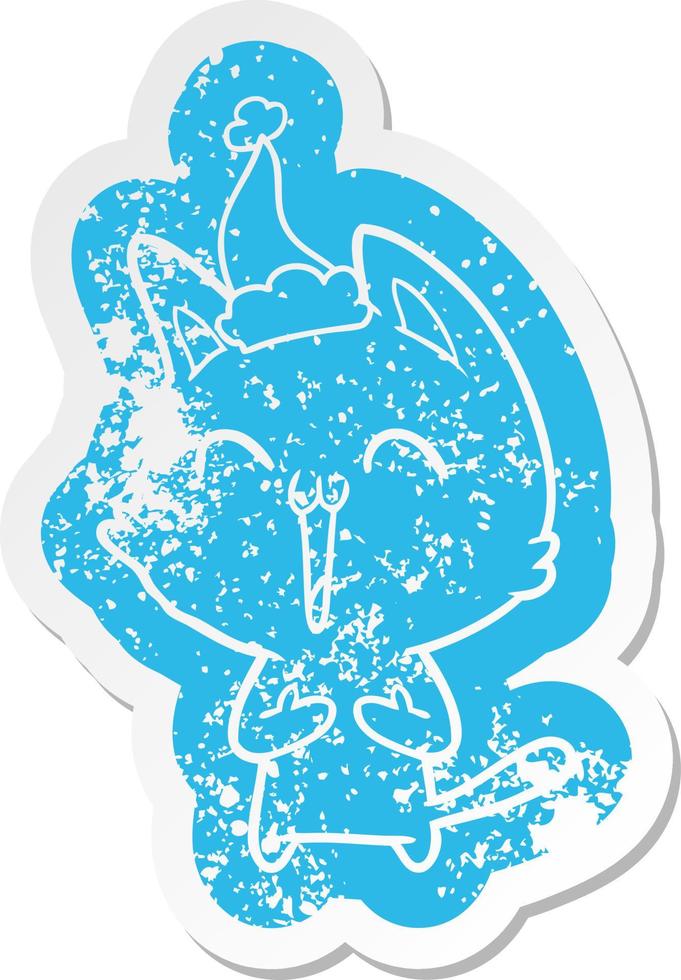 happy cartoon distressed sticker of a cat wearing santa hat vector
