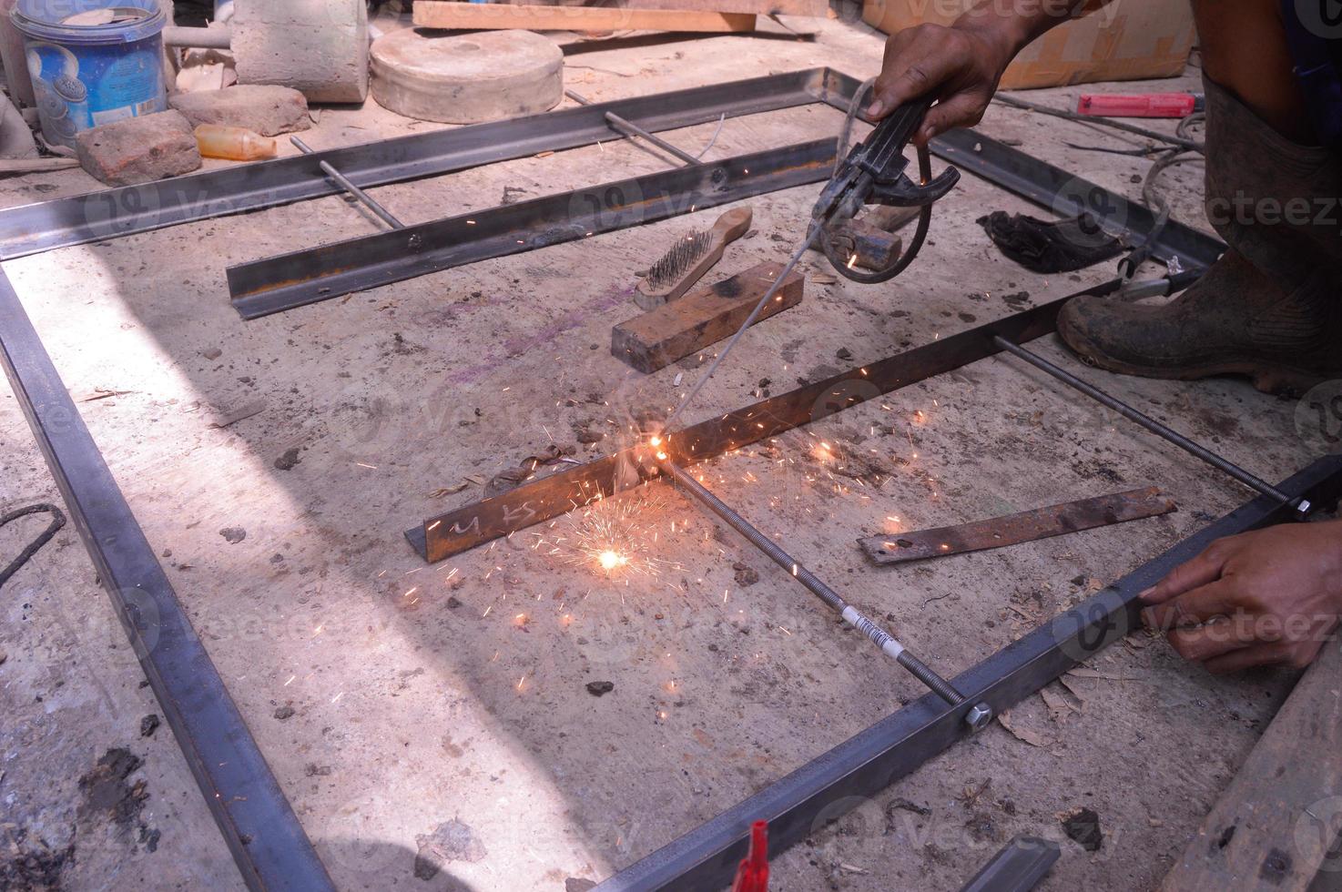 a worker welding iron for a table. Electric welding. manual welding. photo