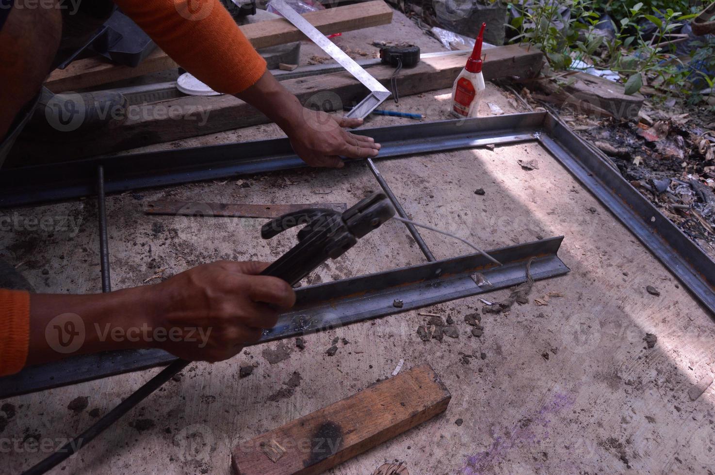 a worker welding iron for a table. Electric welding. manual welding. photo