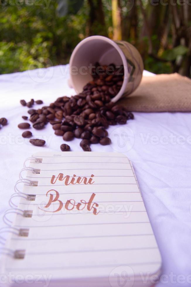 selective focus of coffee beans with diary writing isolated on white photo