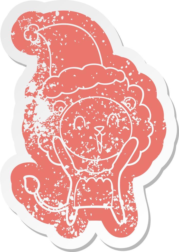 laughing lion cartoon distressed sticker of a wearing santa hat vector