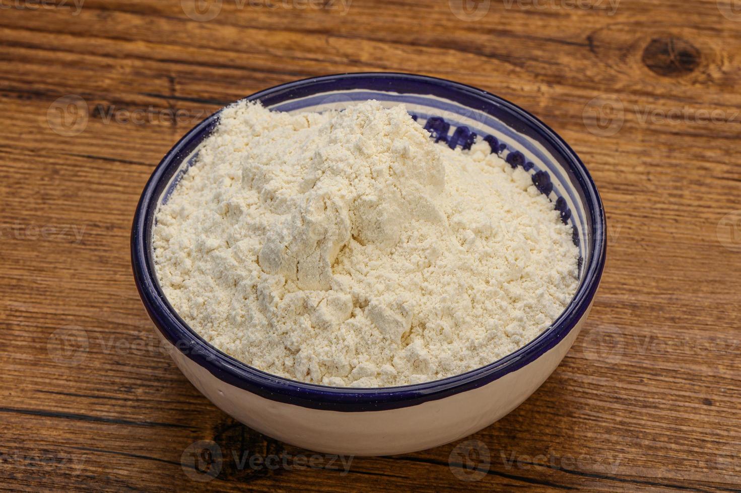 Wheat flour heap in the bowl photo