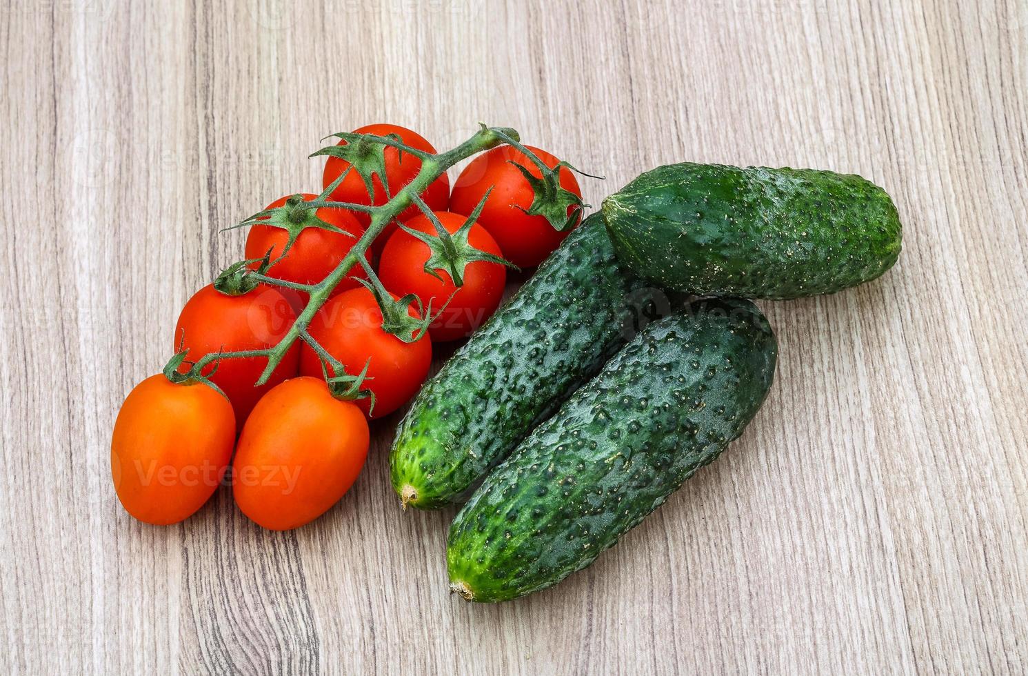 Cucumbers and tomatoes on the branch photo