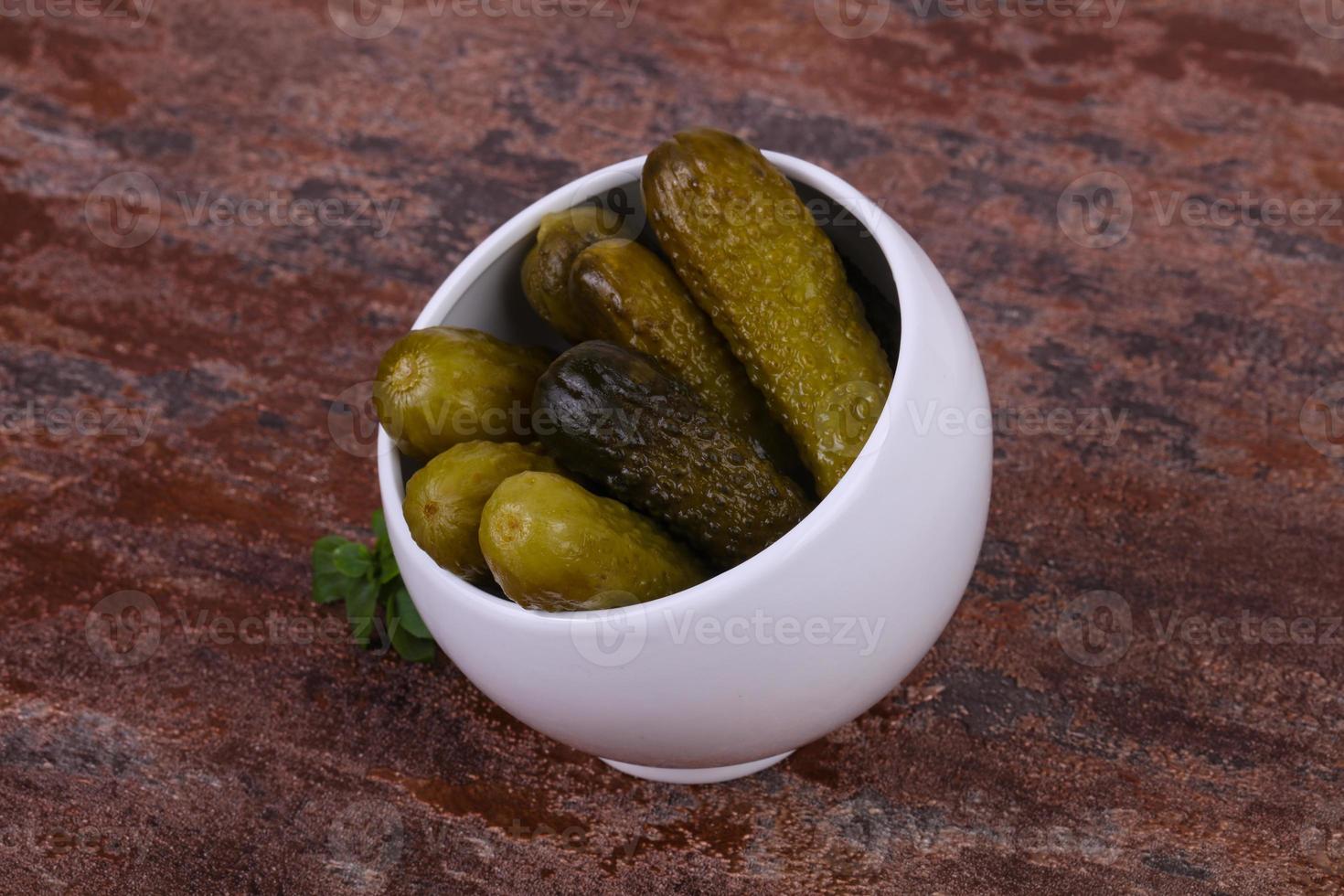 Pickled cucumbers heap in the bowl photo